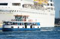 Ferry by the cruise ship