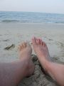 With feet in the sand